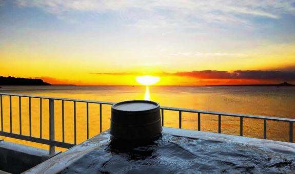 Open-air bath with a view of the setting sun Open-air bath with a view of the setting sun