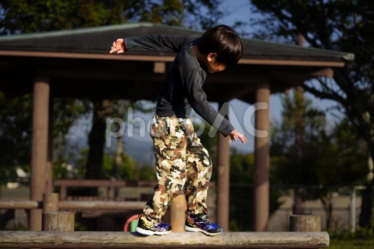 ※＜素材＞公園で元気に遊ぶ小学生の男の子 子供,アスレチック,平均台の写真素材