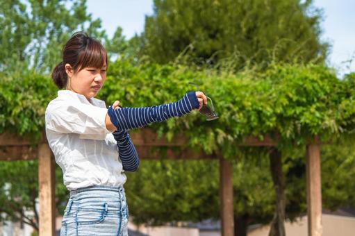 Woman wearing an arm cover, JPG Woman wearing an arm cover, extremely hot day, intense heat, ultraviolet, JPG