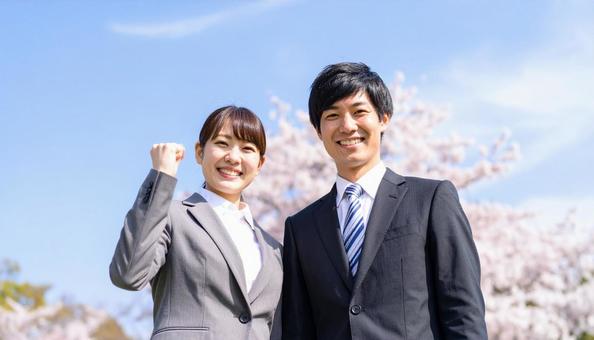 ガッツポーズをする笑顔のビジネスマン男女 ガッツポーズをする笑顔のビジネスマン男女の写真