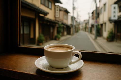 窓越しの街とコーヒーの写真